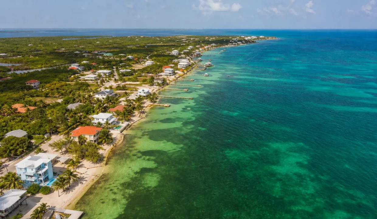 Aerial view of beachfront properties and blue ocean in a Belize coastal town