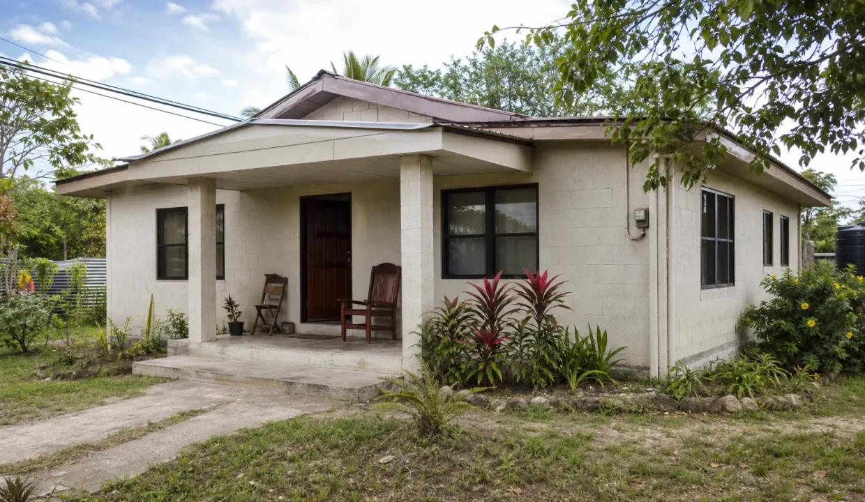 Modest concrete home typical of affordable mainland Belize property under $100,000